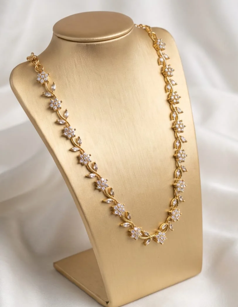 This Gold Plated Floral Vine Necklace Features Sparkling White Cubic Zirconia Crystal Flowers And Leaf Shaped Accents.