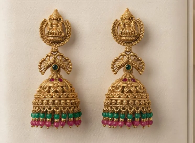 This Traditional South Indian Antique Matte Gold Finish Jhumka Featuring An Intricate Goodness Lakshmi Motif Stud