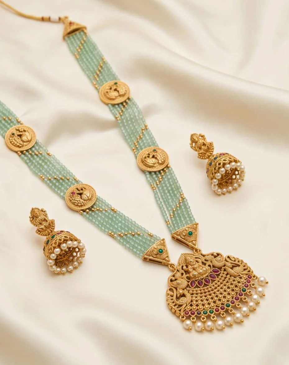 This Mint Green Beaded Traditional Temple Jewellery Set Features An Antique Gold Tone Goddess Lakshmi Pendant And Matching Pearl Accented Jumka Earrings.